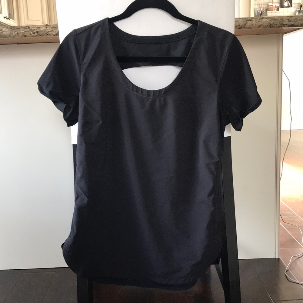 Lululemon Black workout shirt with capped sleeves and slight open back. Size 8